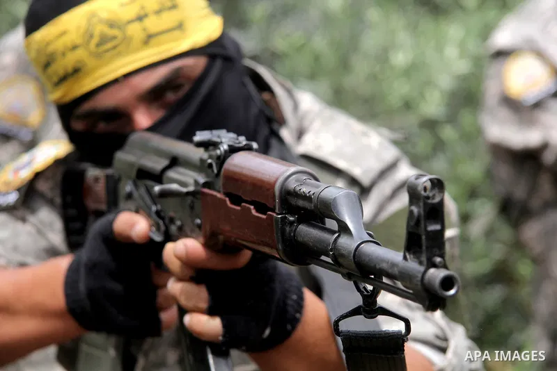 A masked Palestinian militant of al-Aqsa Martyrs' Brigades, a group linked to the Fatah movement, demonstrates his skills during a training in in central Gaza Strip on May 24, 2015. Photo by Nidal Alwaheidi