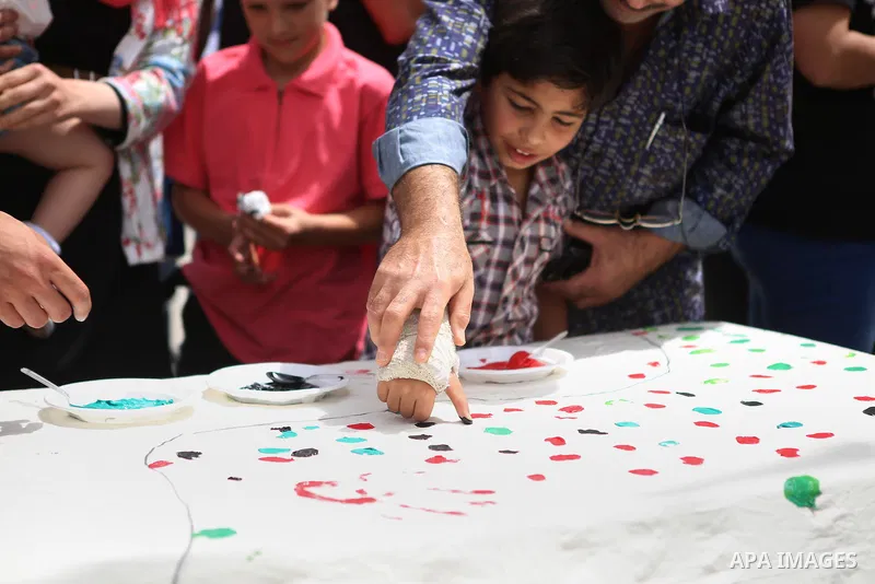 Palestinians lay hands imprint as they take part in a rally marking the 67th anniversary of the "Nakba, in the West Bank city of Ramallah, on May 26, 2015. Photo by Shadi Hatem