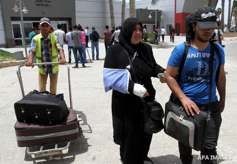 Palestinians coming from Egypt arrive to the Gaza Strip through the Rafah border crossing between Egypt and southern Gaza Strip May 26, 2015. Egyptian authorities opened the Rafah crossing on Tuesday, for the first time...