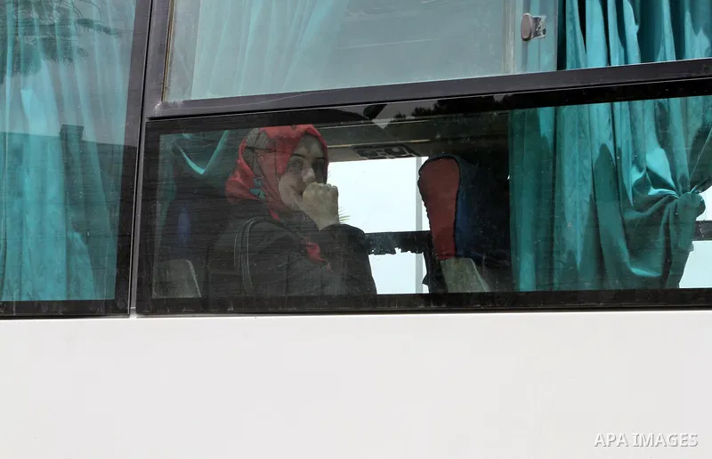A Palestinian woman sits in a bus as she return to Gaza, at the Rafah border crossing between Egypt and southern Gaza Strip May 26, 2015. Egyptian authorities opened the Rafah crossing on Tuesday, for the first time in n...