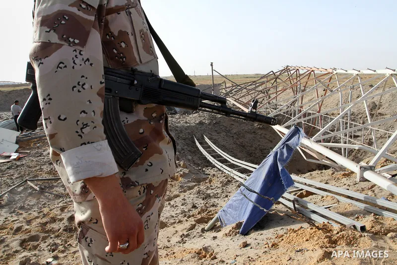 A Palestinian security man looks at a crater on the ground following an Israeli airstrike in the southern Gaza Strip near the town, of Rafah on May 27,2015. The Israeli air force carried out four strikes on militant targ...