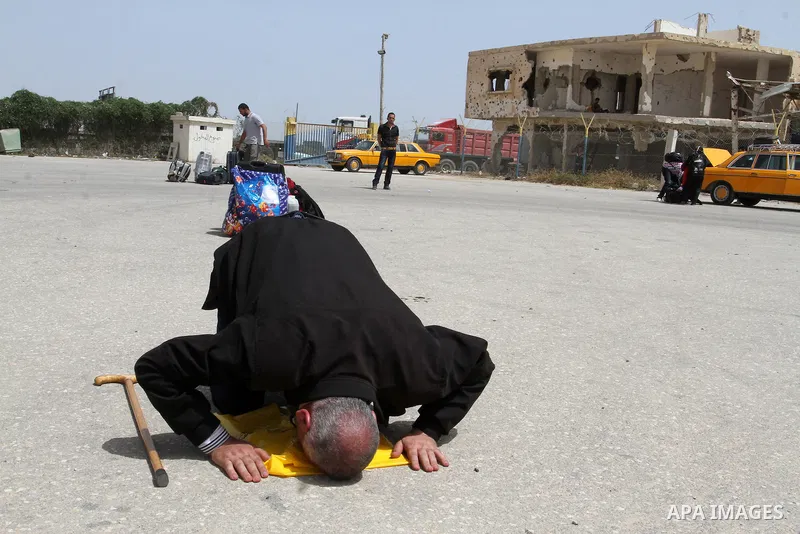 A Palestinian man prays upon his return to Gaza through the Rafah border crossing between Egypt and southern Gaza Strip May 27, 2015. Egyptian authorities opened the Rafah crossing on Tuesday and Wednesday, for the first...