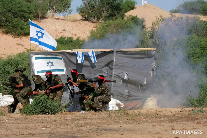 Masked Palestinian militants of the National Resistance Brigades, a group linked to the Democratic Front for the Liberation of Palestine, demonstrate their skills during a training exercise in Khan Younis in the southern...