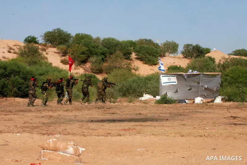 Masked Palestinian militants of the National Resistance Brigades, a group linked to the Democratic Front for the Liberation of Palestine, demonstrate their skills during a training exercise in Khan Younis in the southern...