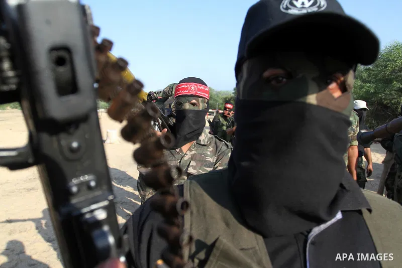 Masked Palestinian militants of the National Resistance Brigades, a group linked to the Democratic Front for the Liberation of Palestine, demonstrate their skills during a training exercise in Khan Younis in the southern...