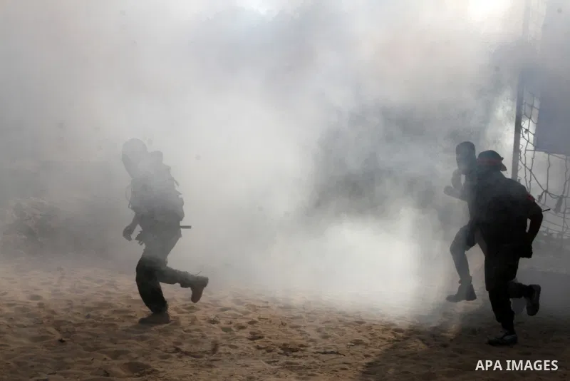 Masked Palestinian militants of the National Resistance Brigades, a group linked to the Democratic Front for the Liberation of Palestine, demonstrate their skills during a training exercise in Khan Younis in the southern...