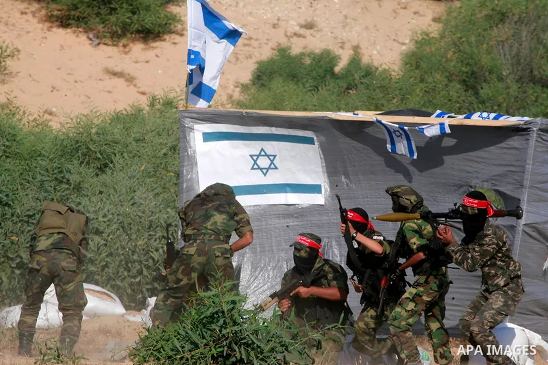 Masked Palestinian militants of the National Resistance Brigades, a group linked to the Democratic Front for the Liberation of Palestine, demonstrate their skills during a training exercise in Khan Younis in the southern...