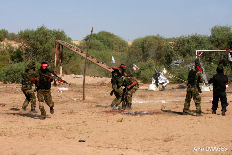 Masked Palestinian militants of the National Resistance Brigades, a group linked to the Democratic Front for the Liberation of Palestine, demonstrate their skills during a training exercise in Khan Younis in the southern...