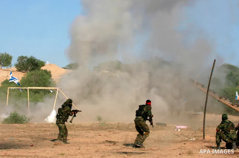 Masked Palestinian militants of the National Resistance Brigades, a group linked to the Democratic Front for the Liberation of Palestine, demonstrate their skills during a training exercise in Khan Younis in the southern...