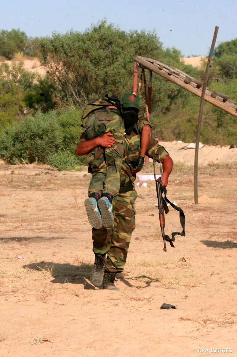 Masked Palestinian militants of the National Resistance Brigades, a group linked to the Democratic Front for the Liberation of Palestine, demonstrate their skills during a training exercise in Khan Younis in the southern...
