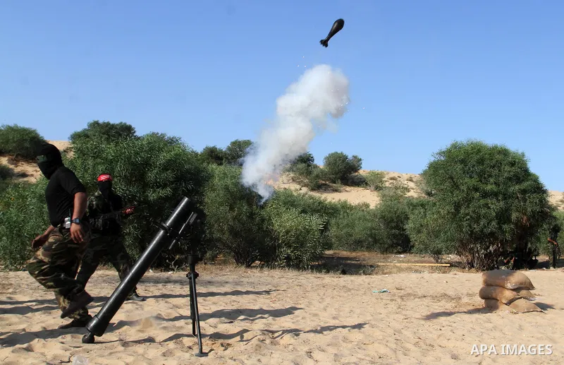 Masked Palestinian militants of the National Resistance Brigades, a group linked to the Democratic Front for the Liberation of Palestine, demonstrate their skills during a training exercise in Khan Younis in the southern...