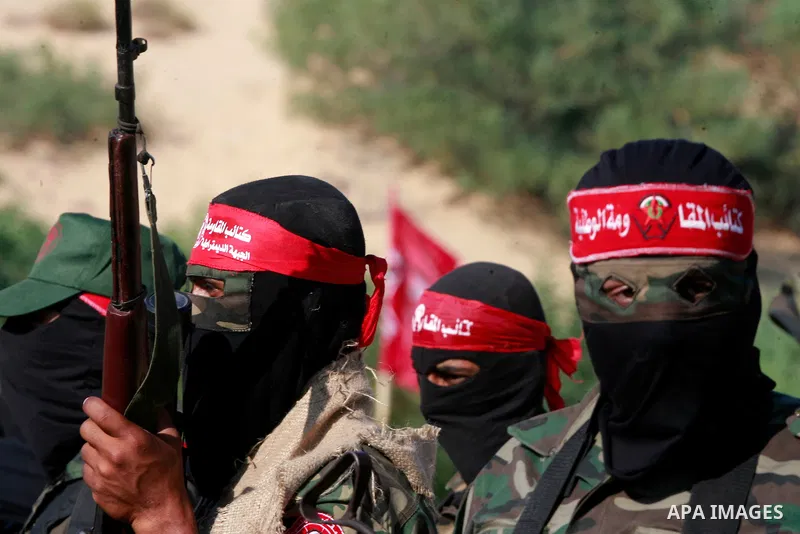Masked Palestinian militants of the National Resistance Brigades, a group linked to the Democratic Front for the Liberation of Palestine, demonstrate their skills during a training exercise in Khan Younis in the southern...