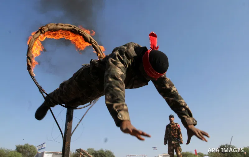 Masked Palestinian militants of the National Resistance Brigades, a group linked to the Democratic Front for the Liberation of Palestine, demonstrate their skills during a training exercise in Khan Younis in the southern...