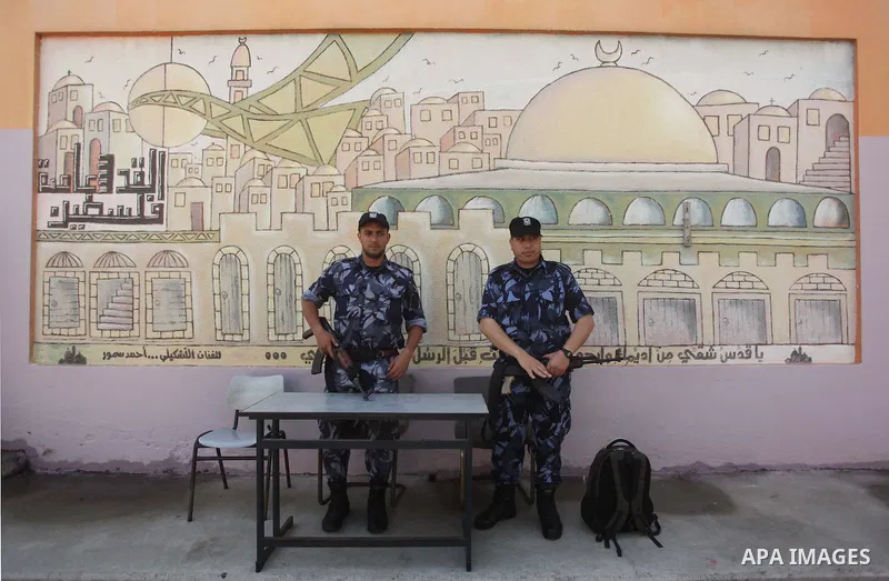 Palestinian Policemen stand guard during the first day of high school exams, known as "Tawjihi", in Gaza city on May 30, 2015. Nearly 81,000 Palestinian students sat for the first session of their high school exams seeki...