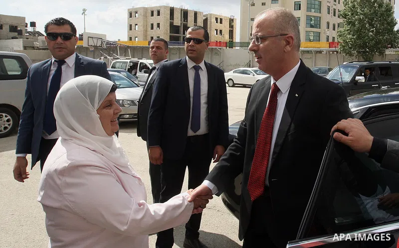 Palestinian Prime Minister Rami Hamdallah visits a school during the first day of high school exams, known as "Tawjihi", in the West Bank city of Ramallah, on May 30, 2015. Nearly 81,000 Palestinian students sat for the...