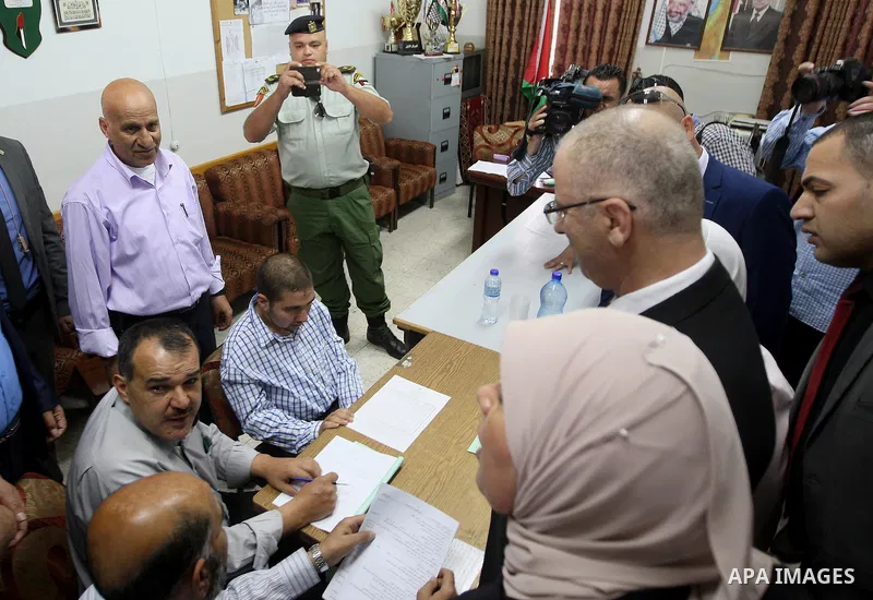 Palestinian Prime Minister Rami Hamdallah visits a school during the first day of high school exams, known as "Tawjihi", in the West Bank city of Ramallah, on May 30, 2015. Nearly 81,000 Palestinian students sat for the...