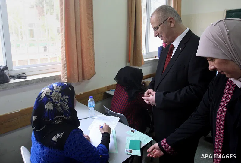 Palestinian Prime Minister Rami Hamdallah visits a school during the first day of high school exams, known as "Tawjihi", in the West Bank city of Ramallah, on May 30, 2015. Nearly 81,000 Palestinian students sat for the...