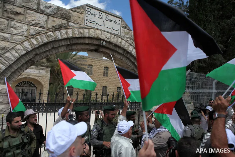 Palestinian protesters argue with Israeli border policemen during a demonstration outside al-Barak building, near al-Aroub Palestinian refugee camp, just north the West Bank town of Hebron on May 30, 2015, against the sa...
