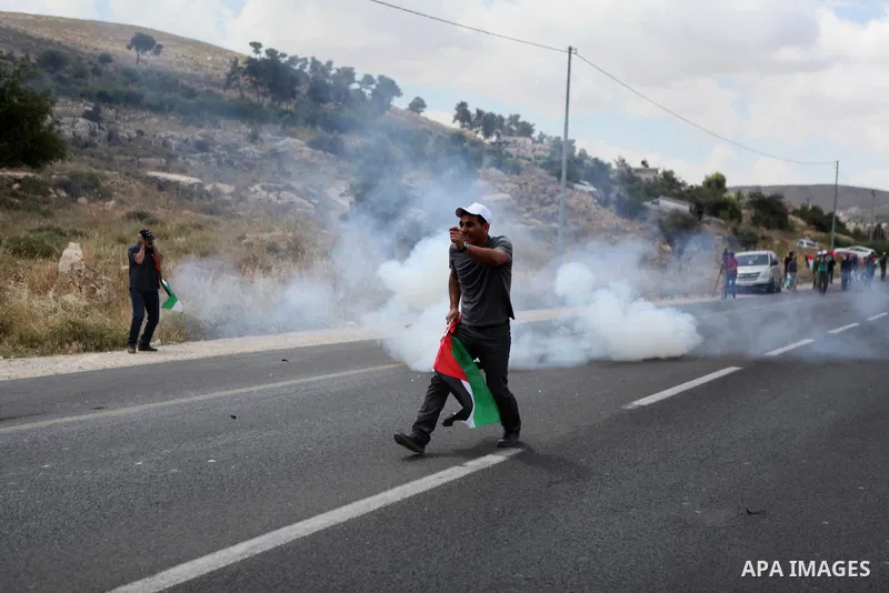 Palestinian protesters argue with Israeli border policemen during a demonstration outside al-Barak building, near al-Aroub Palestinian refugee camp, just north the West Bank town of Hebron on May 30, 2015, against the sa...