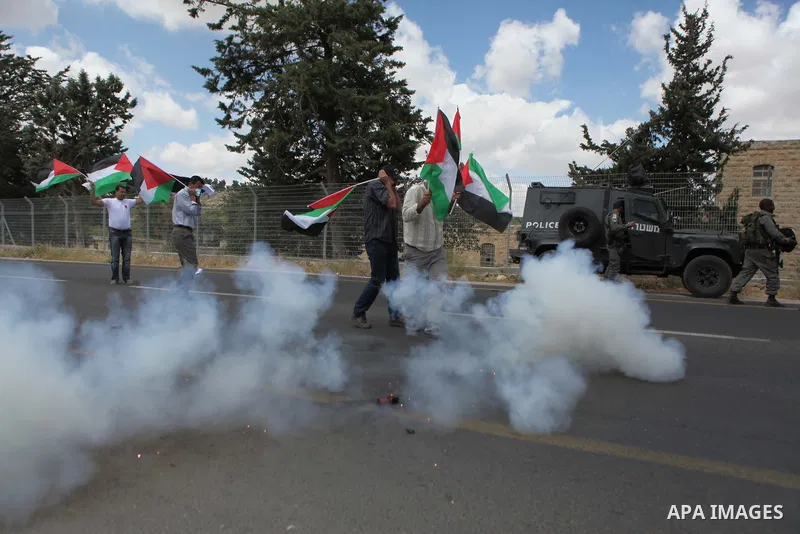 Palestinian protesters argue with Israeli border policemen during a demonstration outside al-Barak building, near al-Aroub Palestinian refugee camp, just north the West Bank town of Hebron on May 30, 2015, against the sa...