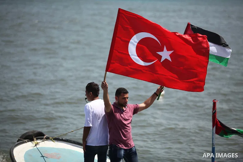 Palestinians hold flags as they ride a boat during a rally marking the 5th anniversary of the Mavi Marmara Gaza flotilla incident, at the seaport of Gaza City May 31, 2015. Nine activists, eight Turkish and one Turkish-A...