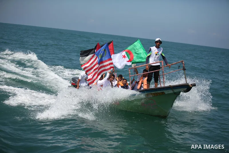 Palestinians hold flags as they ride a boat during a rally marking the 5th anniversary of the Mavi Marmara Gaza flotilla incident, at the seaport of Gaza City May 31, 2015. Nine activists, eight Turkish and one Turkish-A...