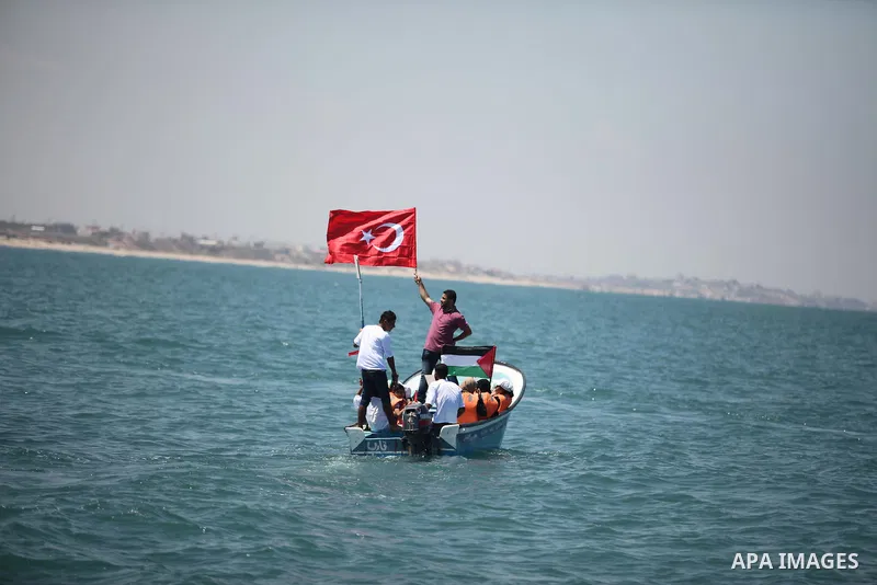 Palestinians hold flags as they ride a boat during a rally marking the 5th anniversary of the Mavi Marmara Gaza flotilla incident, at the seaport of Gaza City May 31, 2015. Nine activists, eight Turkish and one Turkish-A...