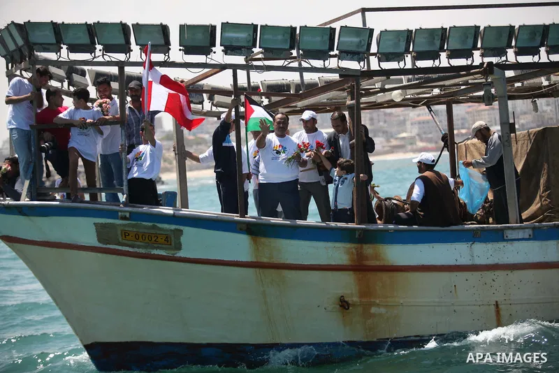 Palestinians hold flags as they ride a boat during a rally marking the 5th anniversary of the Mavi Marmara Gaza flotilla incident, at the seaport of Gaza City May 31, 2015. Nine activists, eight Turkish and one Turkish-A...