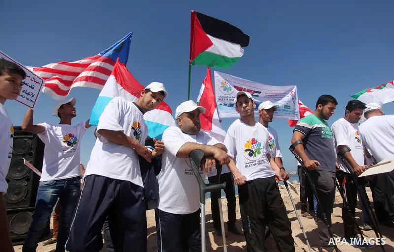 Palestinians hold flags during a rally marking the 5th anniversary of the Mavi Marmara Gaza flotilla incident, at the seaport of Gaza City May 31, 2015. Nine activists, eight Turkish and one Turkish-American, died on May...