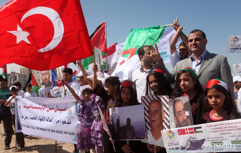 Palestinians hold flags during a rally marking the 5th anniversary of the Mavi Marmara Gaza flotilla incident, at the seaport of Gaza City May 31, 2015. Nine activists, eight Turkish and one Turkish-American, died on May...