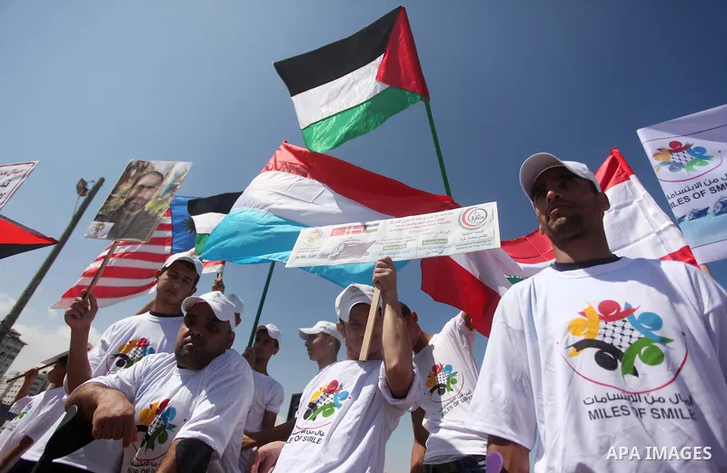 Palestinians hold flags during a rally marking the 5th anniversary of the Mavi Marmara Gaza flotilla incident, at the seaport of Gaza City May 31, 2015. Nine activists, eight Turkish and one Turkish-American, died on May...