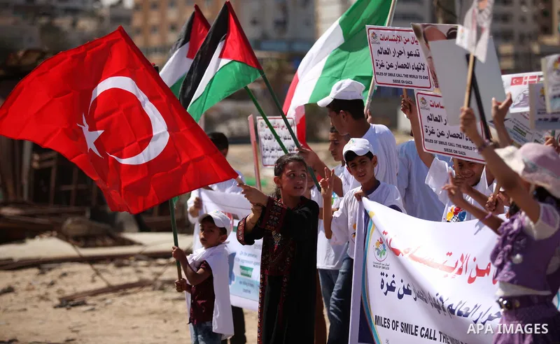 Palestinians hold flags during a rally marking the 5th anniversary of the Mavi Marmara Gaza flotilla incident, at the seaport of Gaza City May 31, 2015. Nine activists, eight Turkish and one Turkish-American, died on May...