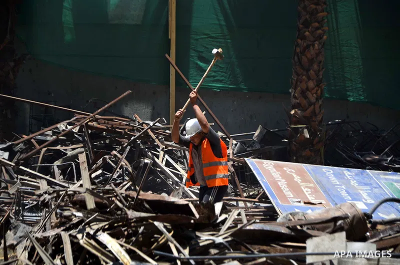 An Egyptian laborer works during the demolition of the headquarters of the once-dominant party of ex-president Hosni Mubarak that was torched during the 2011 uprising that toppled him, on May 31, 2015 in the capital, Cai...