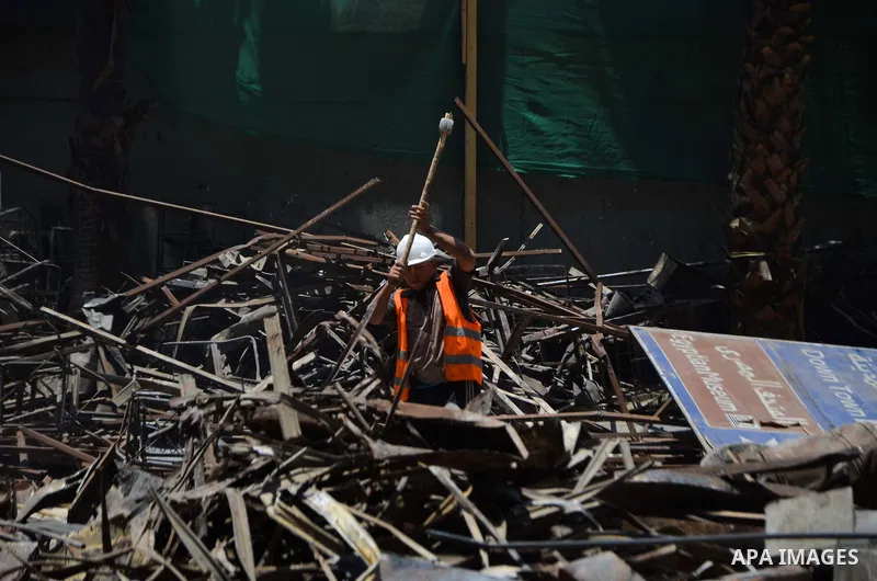 An Egyptian laborer works during the demolition of the headquarters of the once-dominant party of ex-president Hosni Mubarak that was torched during the 2011 uprising that toppled him, on May 31, 2015 in the capital, Cai...