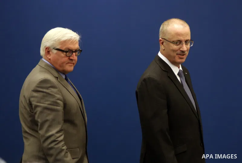 Palestinian Prime Minister Rami Hamdallah and German Foreign Minister Frank-Walter Steinmeier leave following a press conference, in the West Bank City of Ramallah, 31 May 2015. Frank-Walter Steinmeier is on a two day vi...