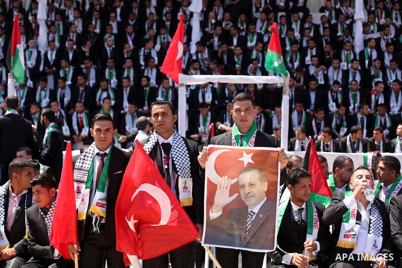 Palestinian grooms take part in a mass wedding ceremony in Gaza city on May 31, 2015. Nearly 4000 Palestinian couples were married in a ceremony funded by Turkish government. Photo by Ashraf Amra