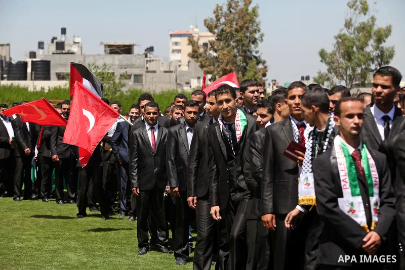 Palestinian grooms take part in a mass wedding ceremony in Gaza city on May 31, 2015. Nearly 4000 Palestinian couples were married in a ceremony funded by Turkish government. Photo by Ashraf Amra