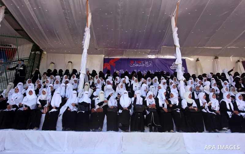 Palestinian brides take part in a mass wedding ceremony in Gaza city on May 31, 2015. Nearly 4000 Palestinian couples were married in a ceremony funded by Turkish government. Photo by Ashraf Amra