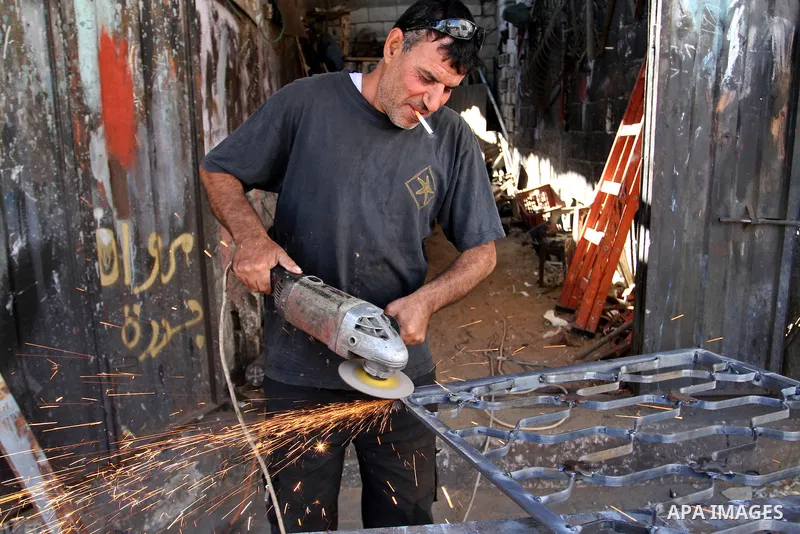 A Palestinian man smokes cigarettes in the southern Gaza Strip City of Rafah, on May 23, 2015. Smuggling through tunnels began several months after Islamic Hamas movement's control of the Gaza Strip and the Israeli block...