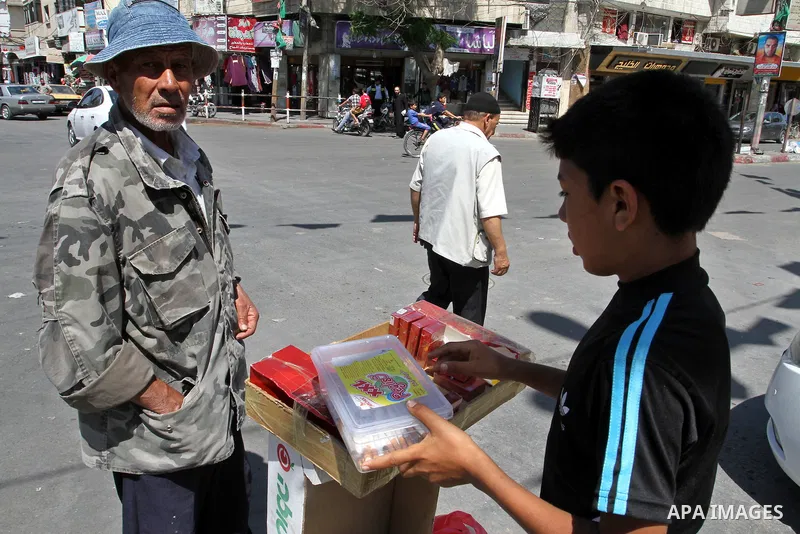 A Palestinian street vendor sells cigarettes in the southern Gaza Strip City of Rafah, on May 31, 2015. Smuggling through tunnels began several months after Islamic Hamas movement's control of the Gaza Strip and the Isra...