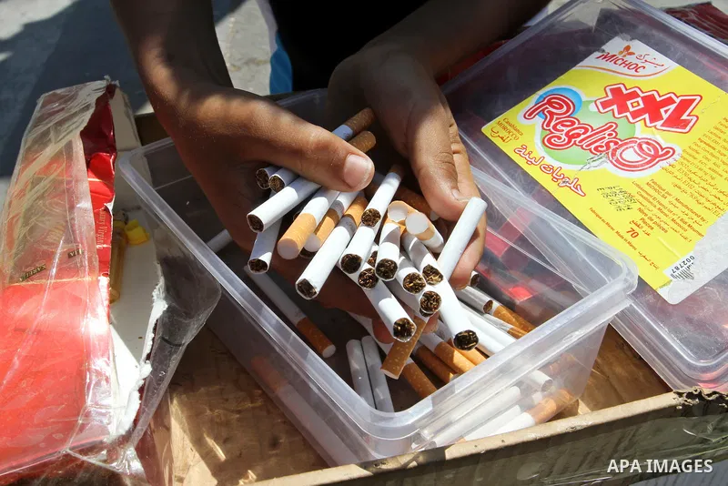 A Palestinian street vendor sells cigarettes in the southern Gaza Strip City of Rafah, on May 31, 2015. Smuggling through tunnels began several months after Islamic Hamas movement's control of the Gaza Strip and the Isra...