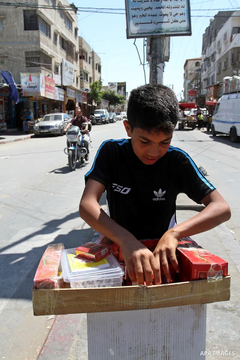 A Palestinian street vendor sells cigarettes in the southern Gaza Strip City of Rafah, on May 31, 2015. Smuggling through tunnels began several months after Islamic Hamas movement's control of the Gaza Strip and the Isra...