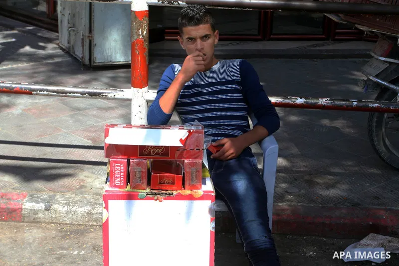 A Palestinian street vendor sells cigarettes in the southern Gaza Strip City of Rafah, on May 31, 2015. Smuggling through tunnels began several months after Islamic Hamas movement's control of the Gaza Strip and the Isra...