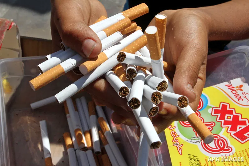 A Palestinian street vendor sells cigarettes in the southern Gaza Strip City of Rafah, on May 31, 2015. Smuggling through tunnels began several months after Islamic Hamas movement's control of the Gaza Strip and the Isra...