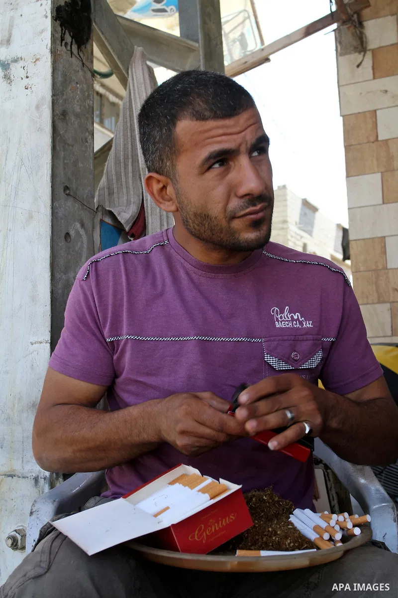 A Palestinian street vendor sells local tobacco cigarettes in the southern Gaza Strip City of Rafah, on May 31, 2015. Smuggling through tunnels began several months after Islamic Hamas movement's control of the Gaza Stri...