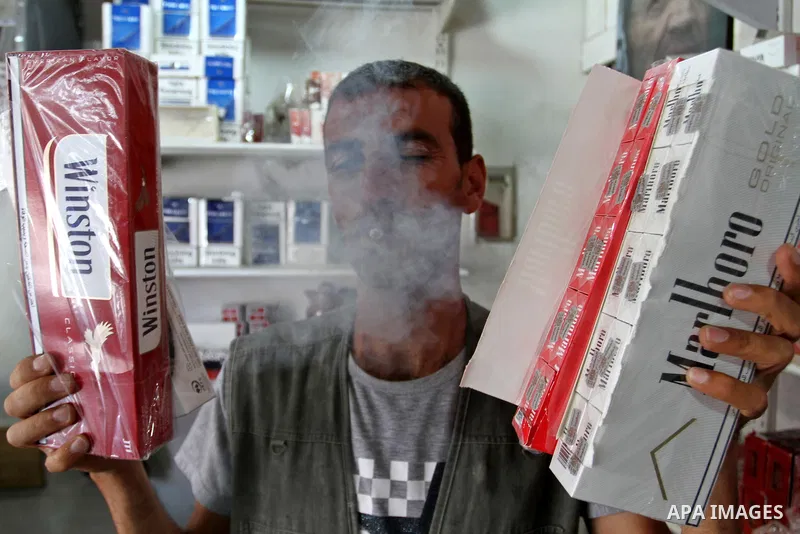 A Palestinian vendor sells cigarettes in the southern Gaza Strip City of Rafah, on May 31, 2015. Smuggling through tunnels began several months after Islamic Hamas movement's control of the Gaza Strip and the Israeli blo...