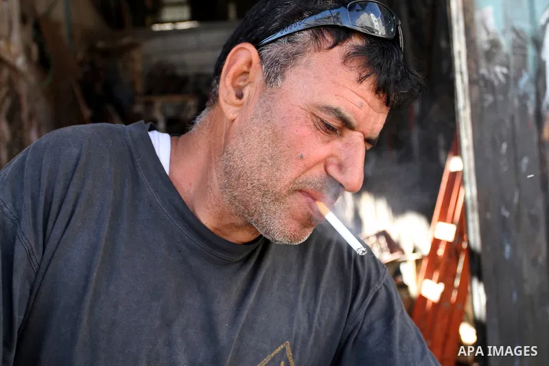 A Palestinian man smokes cigarettes in the southern Gaza Strip City of Rafah, on May 23, 2015. Smuggling through tunnels began several months after Islamic Hamas movement's control of the Gaza Strip and the Israeli block...
