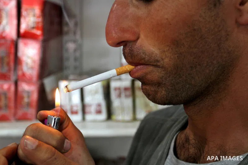 A Palestinian man smokes cigarettes in the southern Gaza Strip City of Rafah, on May 23, 2015. Smuggling through tunnels began several months after Islamic Hamas movement's control of the Gaza Strip and the Israeli block...