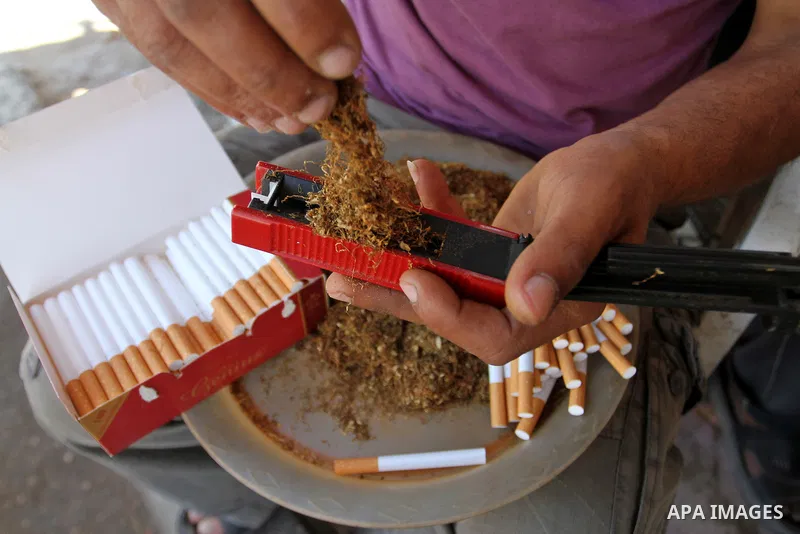 A Palestinian street vendor sells local tobacco cigarettes in the southern Gaza Strip City of Rafah, on May 31, 2015. Smuggling through tunnels began several months after Islamic Hamas movement's control of the Gaza Stri...