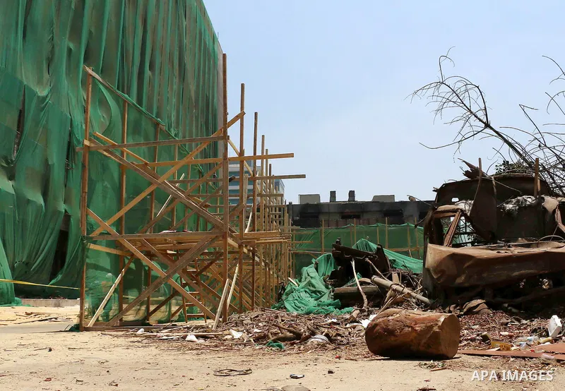 Egyptian laborers work during the demolition of the headquarters of the once-dominant party of ex-president Hosni Mubarak that was torched during the 2011 uprising that toppled him, on May 31, 2015 in the capital, Cairo....
